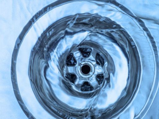 Water going down a plughole in a sink