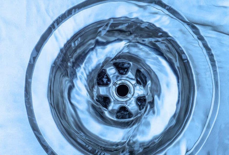 Water going down a plughole in a sink