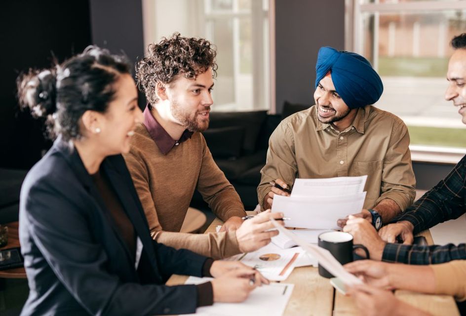 A group of diverse people talking in a meeting
