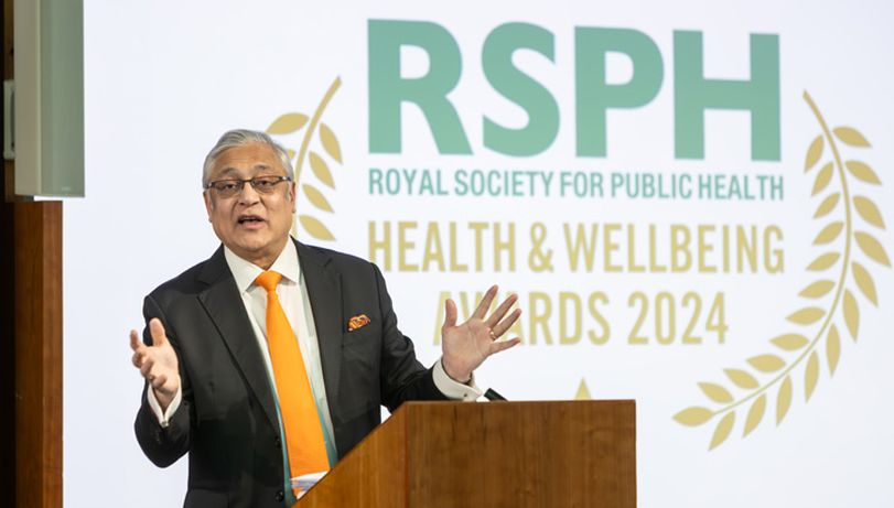 Baron Patel of Bradford delivering on stage stood at a lectern at the 2024 Awards