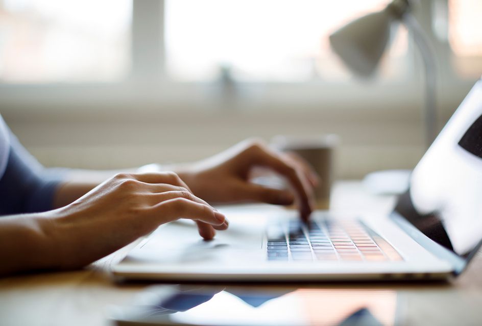 A person typing on a laptop